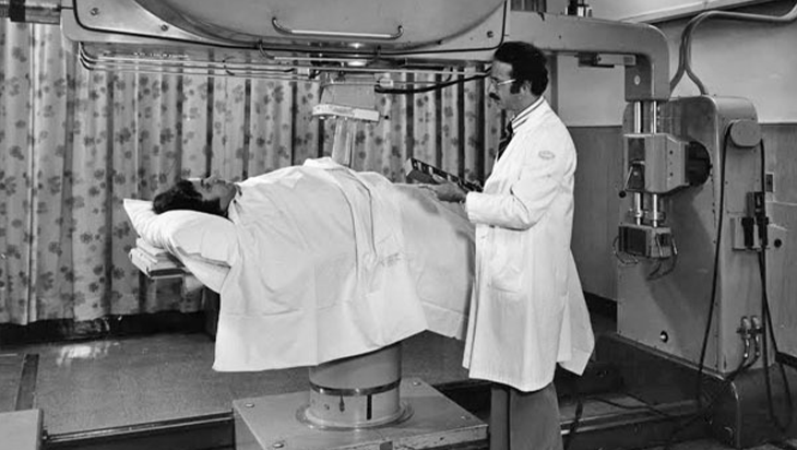 1970's photo of Mevatron with patient and doctor